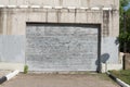 An old, peeling sheet of iron. Fence or garage door. The influence of atmospheric precipitation on the paintwork Royalty Free Stock Photo