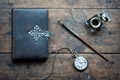 Old pen, old book, clock and vintage inkwell on wooden desk in the old office . Retro style. Conceptual background on history, Royalty Free Stock Photo