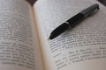 An old pen lying on a book ! Royalty Free Stock Photo