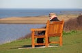 Old pensioner man on coastal bench