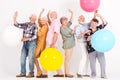 Old people hold balls and they have their hands up