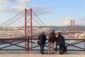 Old people looking on the 25 de Abril Bridge, Lisbon Royalty Free Stock Photo