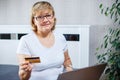 Old people and modern technology concept. Portrait of a 50s mature woman hand holding credit card