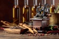 Old pepper mill with cooking utensils, bottles of olive oil, spices and rosemary on a wooden table Royalty Free Stock Photo