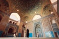 Old Persian mosque and people praying inside of tiled hall