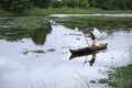 Old person rowing boat in a rural place