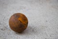 Old petanque ball on cement floor