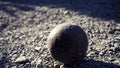 Old petanque balls on the ground. Steel ball on the ground. Light and shadow. Royalty Free Stock Photo