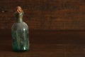 Old pharmacy bottle on antique wood background with copyspace Royalty Free Stock Photo