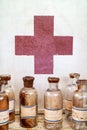 Old pharmacy bottles in front of a cabinet Royalty Free Stock Photo