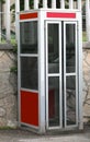 old phone booth closed on the pavement before being decommission Royalty Free Stock Photo