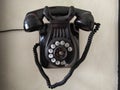 Old phone hanging on the wall. Black color. Vintage Royalty Free Stock Photo