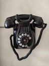 Old phone hanging on the wall. Black color. Vintage Royalty Free Stock Photo