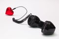 Old phone reciever and cord connection with red heart. Royalty Free Stock Photo