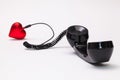 Old phone reciever and cord connection with red heart. Royalty Free Stock Photo