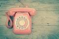 Old phone rotary vintage retro stlye telephone on wood table top