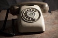 Old phone on a table ,Old vintage phone with rotary disc on wooden table grunge background Royalty Free Stock Photo