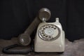 Old phone on a table , rotary disc on wooden table grunge background Royalty Free Stock Photo