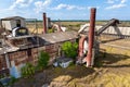 Old phosphate processing plant in central Florida with weathered structure, conveyor belts and overgrown vegetation. Royalty Free Stock Photo