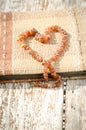 Old photo album with amber necklace heart Royalty Free Stock Photo