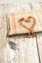 Old photo album with amber necklace heart Royalty Free Stock Photo