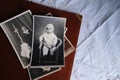 Old photo albums lie on white mint tablecloth, vintage photographs of 1960, concept of family tree, genealogy, childhood memories Royalty Free Stock Photo