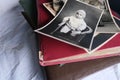 Old photo albums lie on a white mint tablecloth, vintage photographs of 1960, concept of family tree, genealogy, childhood Royalty Free Stock Photo