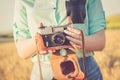 Old photo camera in a hands of girls. Royalty Free Stock Photo