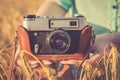 Old photo camera in a hands of girls. Royalty Free Stock Photo