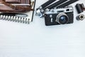 Old photo camera with leather case, tripod, pencil and notebook Royalty Free Stock Photo