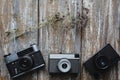 Old photo cameras on old wooden texture. V