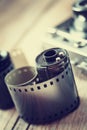 Old photo film rolls, cassette and retro camera on background. Royalty Free Stock Photo