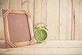 Old photo frame and clock on wooden table over wood background Royalty Free Stock Photo