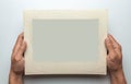 Old photo in frame in the hands of man. Empty template for picture, mock-up. Gray background. Royalty Free Stock Photo