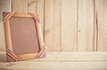 Old photo frame on wooden table over wood background Royalty Free Stock Photo