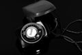 Old photo light meter in a case on a mirror table Royalty Free Stock Photo