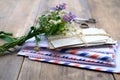 Old photographs, envelopes from letters, wild flowers bouquet on table, home archive documents, concept of family tree, genealogy Royalty Free Stock Photo