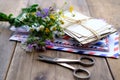 Old photographs, envelopes from letters, wild flowers bouquet on table, home archive documents, concept of family tree, genealogy Royalty Free Stock Photo