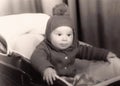 Old photography of a little baby boy in a pram