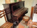 Old piano in the ancient Russian house. The room is aged Russian style