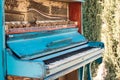 Old piano painted in blue color on the street Royalty Free Stock Photo