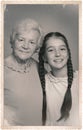 Old picture of cute girl with her grandmother. Portrait for family tree