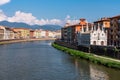 Old picturesque houses at the Arno river waterfront in Pisa, the little church Santa Maria della Spina in the foreground Royalty Free Stock Photo