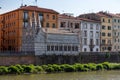 Old picturesque houses at the Arno river waterfront in Pisa, the little church Santa Maria della Spina in the foreground Royalty Free Stock Photo