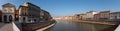 Old picturesque houses at the Arno river waterfront in Pisa, Logge di Banchi at the left Royalty Free Stock Photo