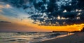 Old pier on background of sunset on beach