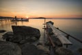 Old Pier, boat and rocks sunset Royalty Free Stock Photo