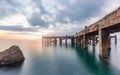 Old pier bridge in beautiful morning sunrise and calmness seascape Royalty Free Stock Photo