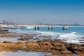 Old pier at Humewood Beach in Port Elizabeth with city buildings in background Royalty Free Stock Photo