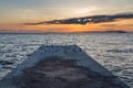 Old pier with lots of seagulls and a ship at sunset Royalty Free Stock Photo